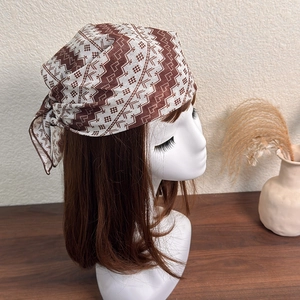 Detail showing Bohemian brown geometric polka dot scarf tied on a model for hair styling
