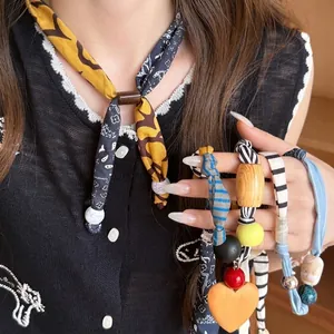 Artistic fabric necklace set with leopard print, wood beads, and heart pendant necklace