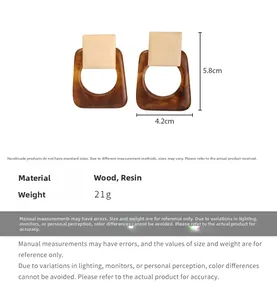 Detail showing geometric wood and resin earrings with dimensions 5.8cm height and 4.2cm width