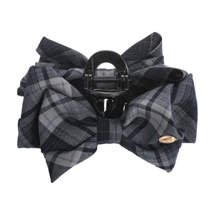 Navy plaid bow hair claw clip with golden metal label on white background