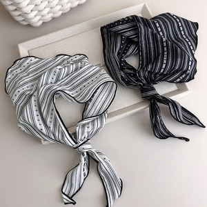 Elegant striped silk neck scarf in black and white colors with wavy edges and soft texture