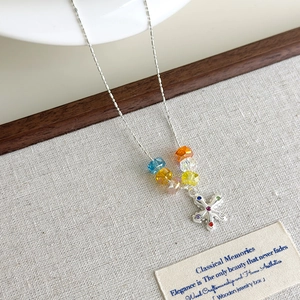 Detailed macro view of colorful crystal beads and a flower pendant with multi-colored gemstones