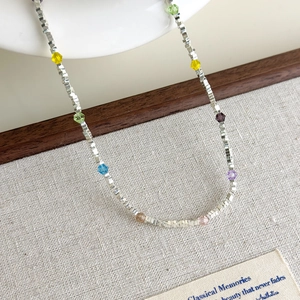 Detail of colorful crystal star beads and silver square chain links for women necklaces
