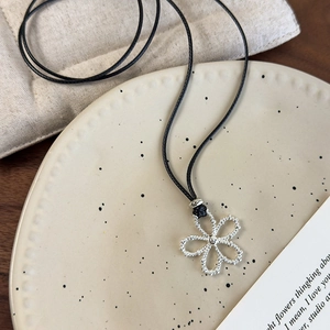 Silver hollow flower pendant necklace with adjustable black wax rope for vacation outfits