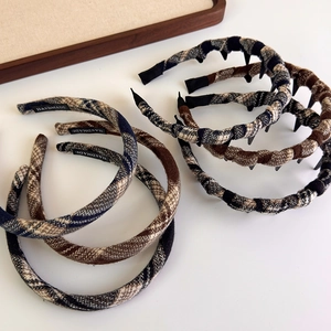 Close-up of handmade plaid fabric headbands with anti-slip teeth in British style