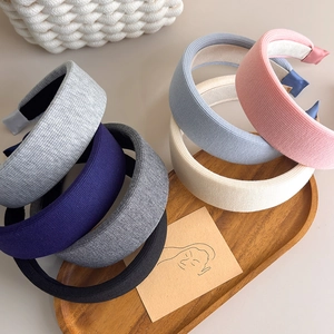 Detail of multi-colored sponge knit headbands showing soft ribbed fabric and thick padded design