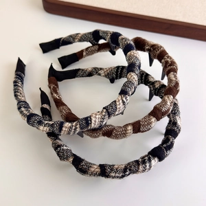 Close-up of woven tweed plaid headbands with anti-slip teeth in three colors