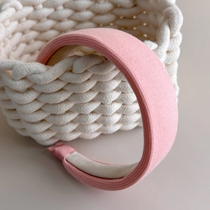 Close-up of pink ribbed knit fabric texture and anti-slip lining on padded headband
