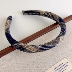 Detailed view of handmade plaid headband fabric texture and professional handmade label