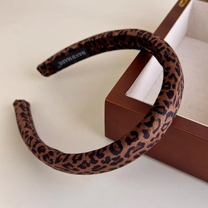 Detail of leopard print sponge headband featuring soft velvet texture and handmade label