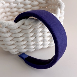 Detail of dark blue knit fabric headband with thick padded design and non-slip inner lining