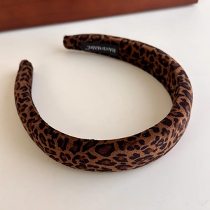 Detail of leopard print velvet headband with thick sponge padding and handmade woven label
