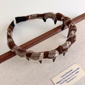 Close-up of vintage brown plaid fabric headband with black non-slip inner teeth