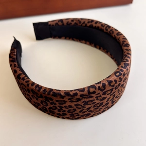 Close-up of leopard print padded headband featuring thick sponge design and fabric texture