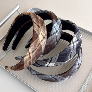 Three vintage plaid padded headbands in brown, blue, and black-white check patterns
