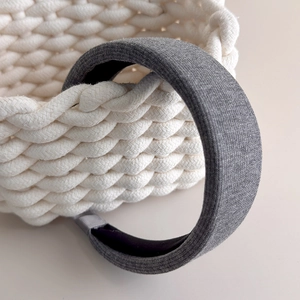 Detailed close-up of dark grey knitted padded headband with soft textured fabric