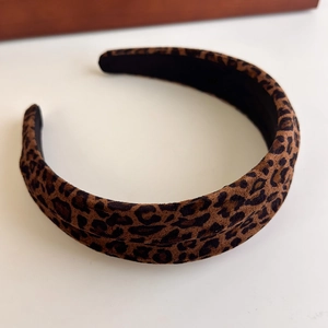 Close-up of leopard print headband with soft velvet texture and retro fashion style