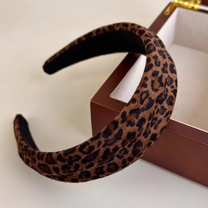 Close-up of leopard print padded headband with textured brown flocking fabric detail