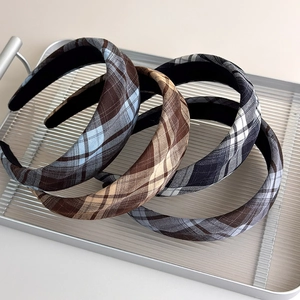 Three-piece French vintage plaid headband set in warm earth tones on a silver tray