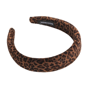 Classic leopard print sponge headband for women with handmade label on white background