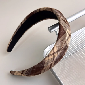 Detail of brown and beige plaid headband with textured fabric and non-slip lining