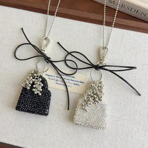 Elegant handbag pendant necklaces with sparkling diamonds and black ribbon bows