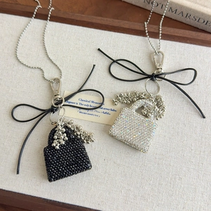 Detail of glittery handbag pendants with sparkling rhinestones and elegant bead chains