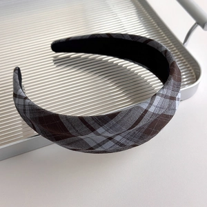 Macro shot of French plaid fabric headband featuring vintage brown and grey checkered pattern