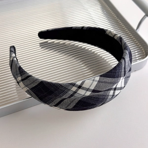 Detail of French vintage black and white checkered fabric headband on silver tray