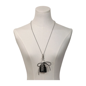 Elegant beaded silver necklace with a black velvet sparkling bag pendant and silk bow