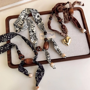 Bohemian paisley silk ribbon necklace with polished wood beads and gold heart pendant