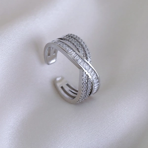 Luxury multilayer crisscross open ring with shimmering cubic zirconia on white silk