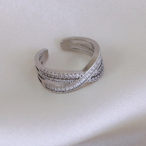 Close-up of luxury minimalist silver ring with multi-row sparkling zircon crossover design