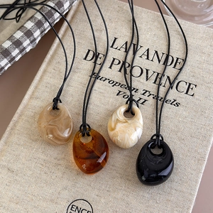 Irregular resin drop pendant necklaces in amber and marble patterns for women