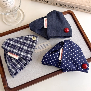 Navy blue plaid and polka dot fabric shark hair clips with handmade labels on a tray