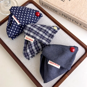 Detail showing navy polka dot and plaid hair claw clip set with handmade labels