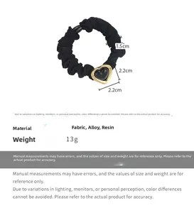 Detail showing dimensions of black heart hair tie with golden alloy and resin heart pendant