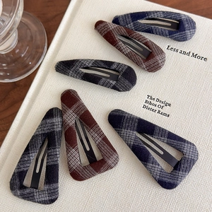Set of 6 classic plaid fabric BB clips in teardrop and triangle shapes on a book