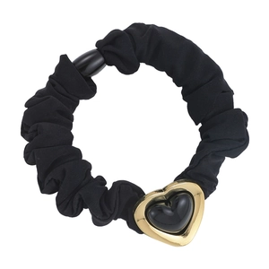 French minimalist black knit hair scrunchie with a vintage gold heart charm detail