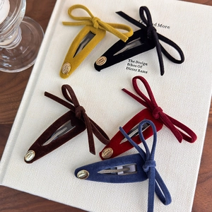 Set of vintage velvet bow hair clips with gold metal buttons in five different colors