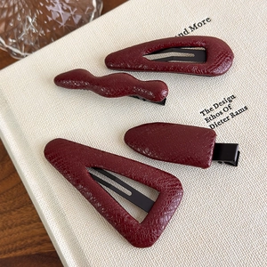 Retro burgundy faux leather hair clip set with geometric shapes and vintage textures