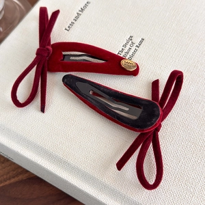Close-up of vintage velvet bow hair clips with gold metal smile happy engraving