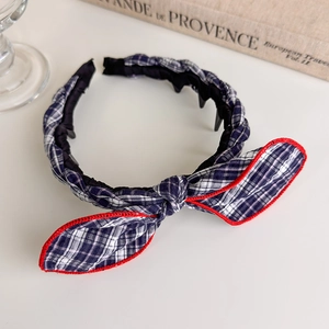 Close-up of checkered headband with red contrast bow and non-slip inner teeth detail