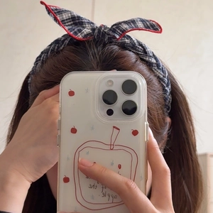 Transparent iPhone Pro case with red apple and blue star patterns in a handheld selfie