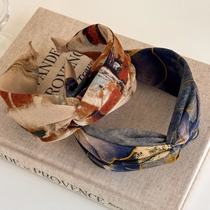 Detail of vintage tie-dye twist headbands in warm oil painting and blue floral prints