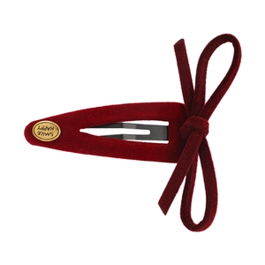 Vintage burgundy velvet bow hair clip with a gold 'SMILE HAPPY' engraved metal plate