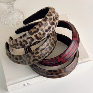 Detail showing high-quality leopard print faux leather headbands in four distinct colors