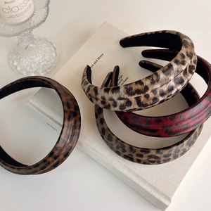 Macro view of leopard print headband with clear faux leather texture and non-slip lining