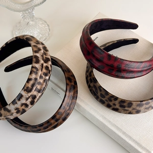 Close-up of four leopard print padded headbands in assorted retro style colors
