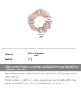 Detailed view of pink lace scrunchie with a 2cm pearl bead showing size and fabric texture